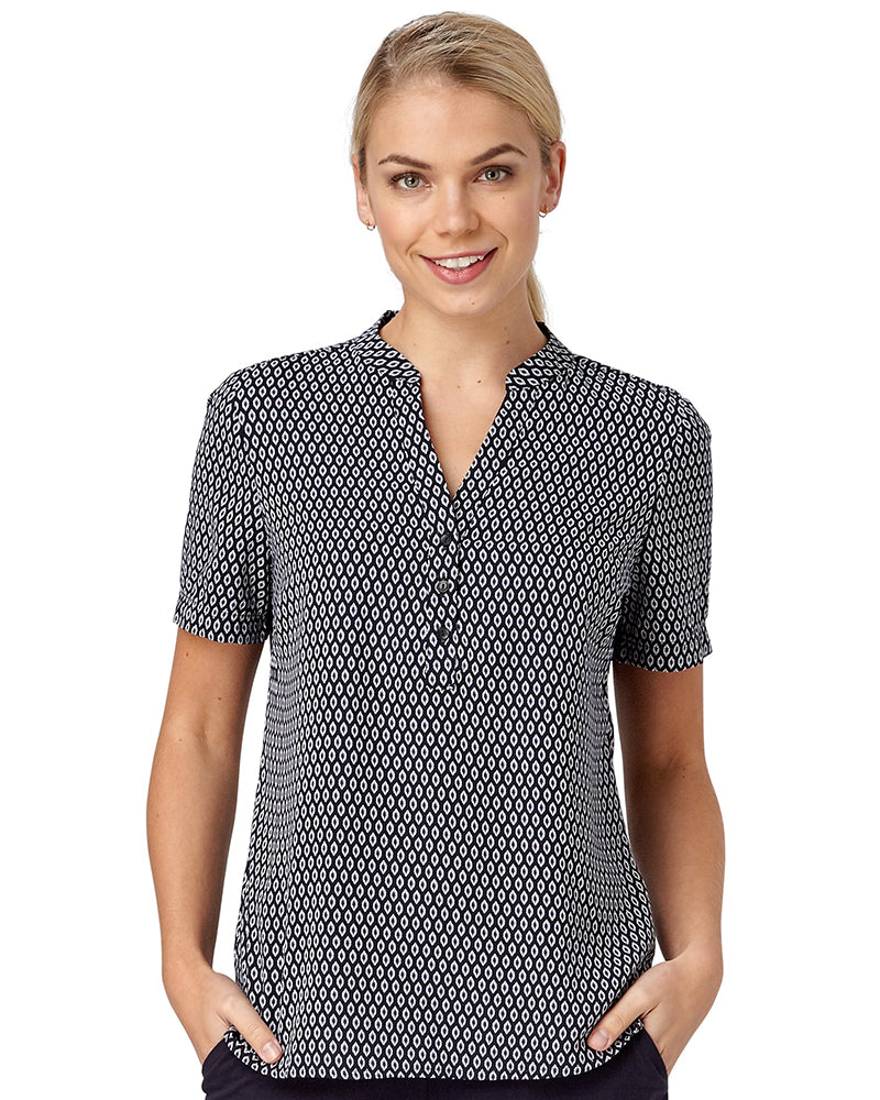Woman In A Navy Pop Over Top With A Shield Print Design