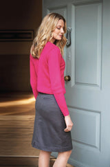 Woman Wearing A Bright pink Blouse And Grey Chino Skirt