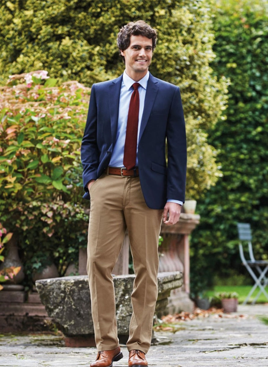 Man Wearing A Navy Slim Fit Chino Business Jacket And Beige Chino Trousers