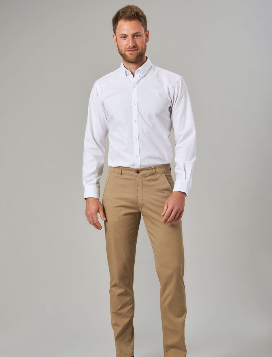 Man Wearing A Pair Of Beige Chino Trousers And White Shirt