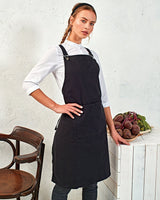 Cook Wearing A Black Apron With Cross Back Tie Design