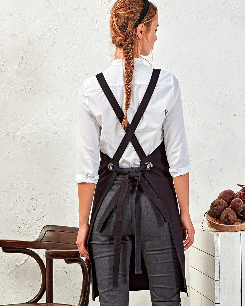 Back Image Of Cook Wearing a Black Apron With Cross Back Tie Design