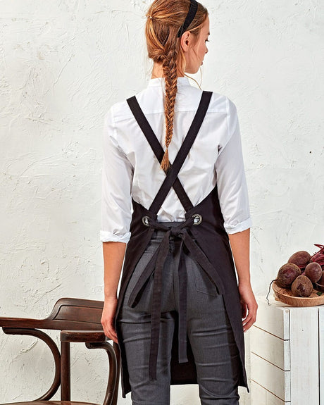 Back Image Of Cook Wearing a Black Apron With Cross Back Tie Design