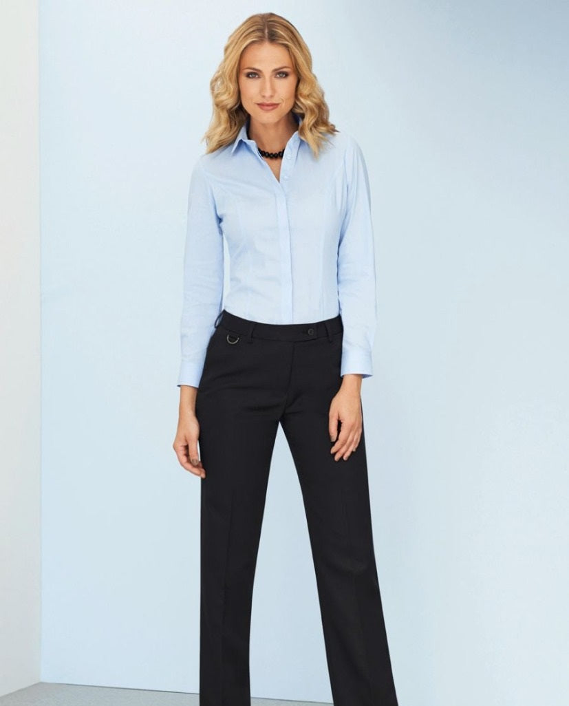 Woman Wearing A Light Blue Long Sleeve Blouse And Navy Tailored Leg Business Trousers